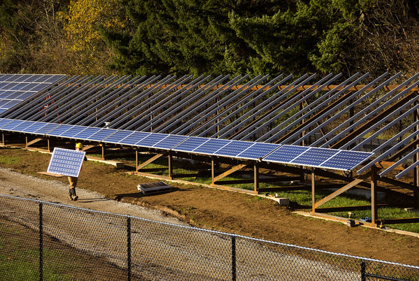 Utility-scale battery storage installation beside a large solar photovoltaic array