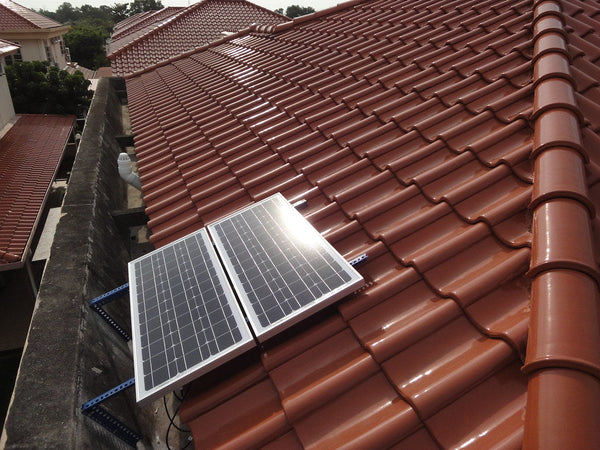 Wall-mounted residential battery backup unit installed beside a home electrical panel